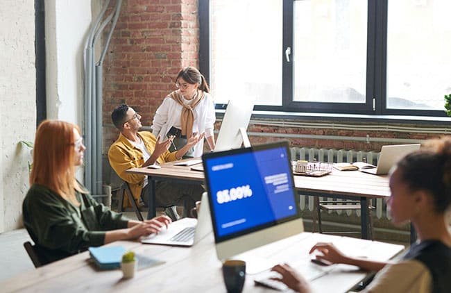 Team of People managing web support plans from an office